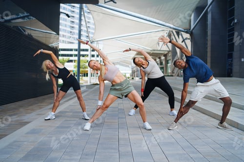 Preview: Group of young and old people doing exercise outdoors in city