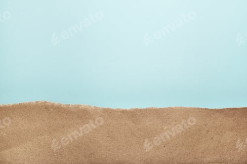 Preview: Torn recycled craft paper on blue backround