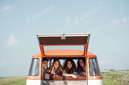 Preview: A group of young friends on a roadtrip through countryside, looking out of window.