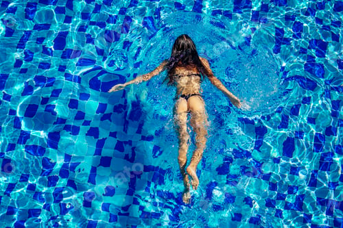 Preview: top view resort and spa vacation villa young woman swimming in the pool enjoying