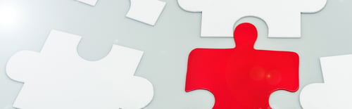 Preview: panoramic shot of red and white jigsaw pieces on grey