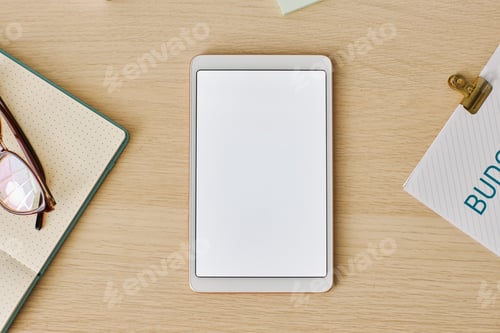 Preview: Minimal top view digital tablet with white screen mockup at light wood desk