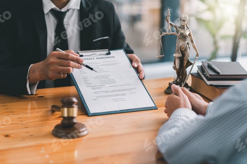 Preview: Lawyer working with client at table in office, focus on hands