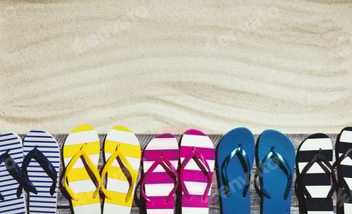 Preview: Set of colorful flip flops on the beach deck
