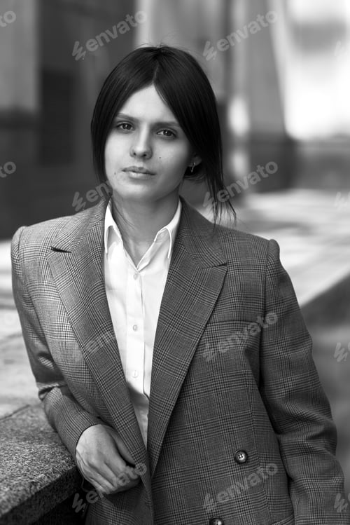 Preview: High fashion portrait of young elegant woman in brown suit walk on the street. enjoy summer lights.