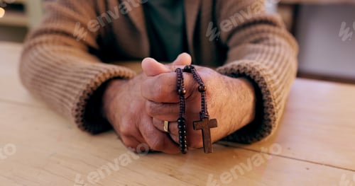Preview: Hands, rosary and cross with closeup for religion, peace and hope at desk, home or praying for wors