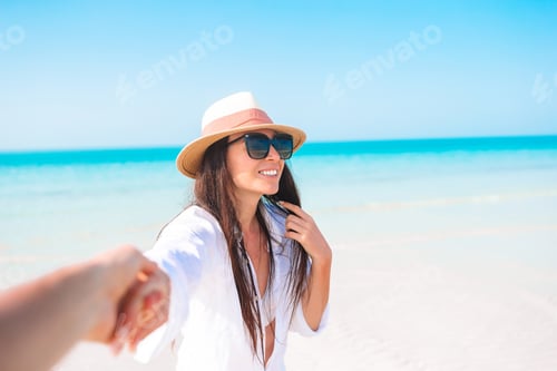 Preview: Woman laying on the beach enjoying summer holidays looking at the sea