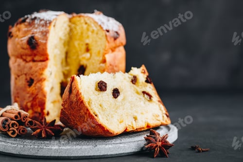 Preview: Traditional Christmas Panettone cake with dried fruits on dark stone background
