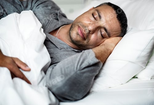 Preview: A man sleeping on a bed