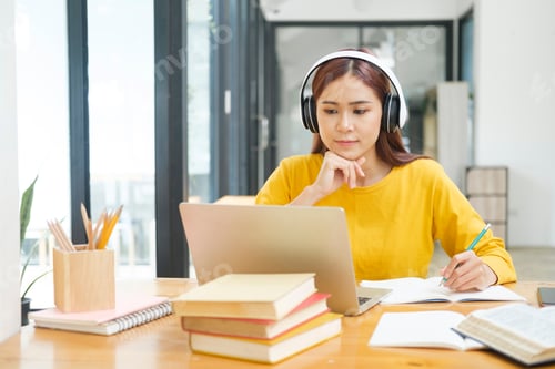 Preview: Young collage student using computer and mobile device studying online.