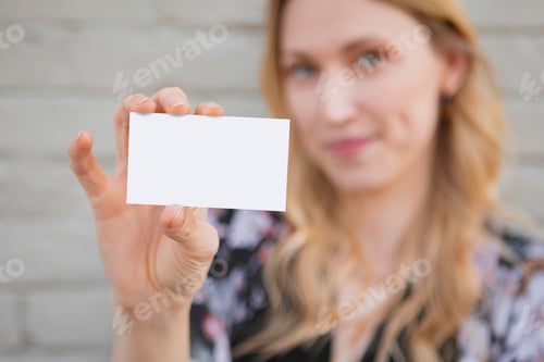 Preview: Cheerful white woman showing her business card