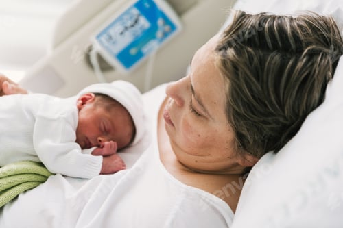Preview: Mother with newborn baby in the hospital room.