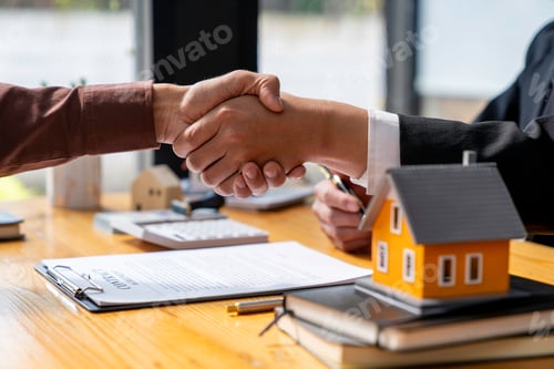 Preview: Successful deal Real estate lease or home purchase concept buyer shakes hands with bank employee aft