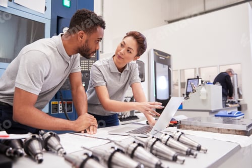 Preview: Two Engineers Using CAD Programming Software On Laptop