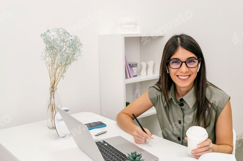Smiling Woman Working at Desk in Bright Office
