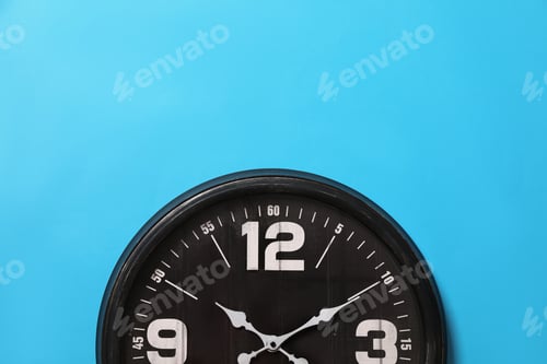 Preview: Stylish analog clock hanging on light blue wall, space for text