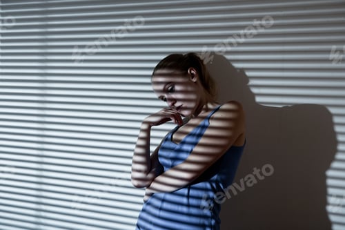 Preview: Portrait of a unhappy and depressed young woman in depressive stripe environment desaturated image