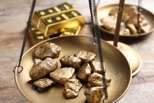 Preview: Scale pan with gold lumps on wooden table, closeup
