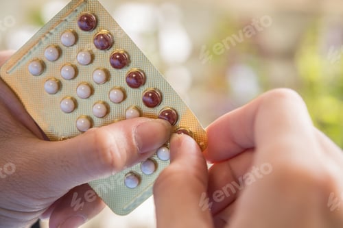 Preview: Woman hand holding a contraceptive panel prevent pregnancy