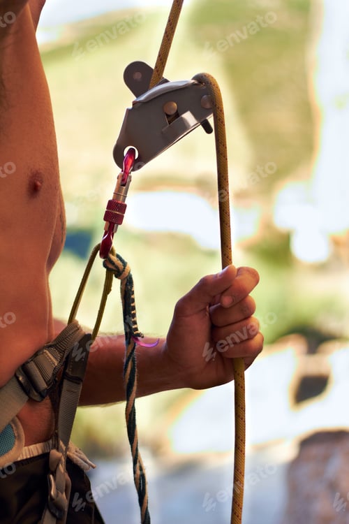 Preview: For the climb. Cropped shot of a young rock climber standing and adjusting his harnesses.