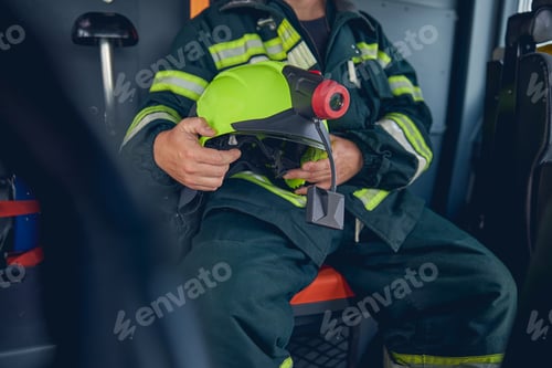 Preview: Portrait of man wearing protective uniform sitting in the machine