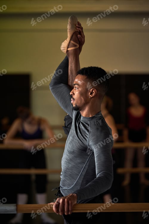 Preview: boy black dancer in a warm-up and dancing in a ballet class