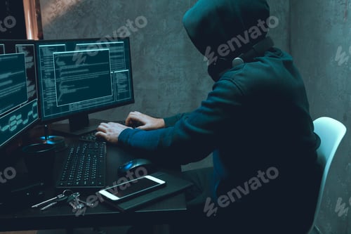 Preview: Hacker programmer using computer in dark room