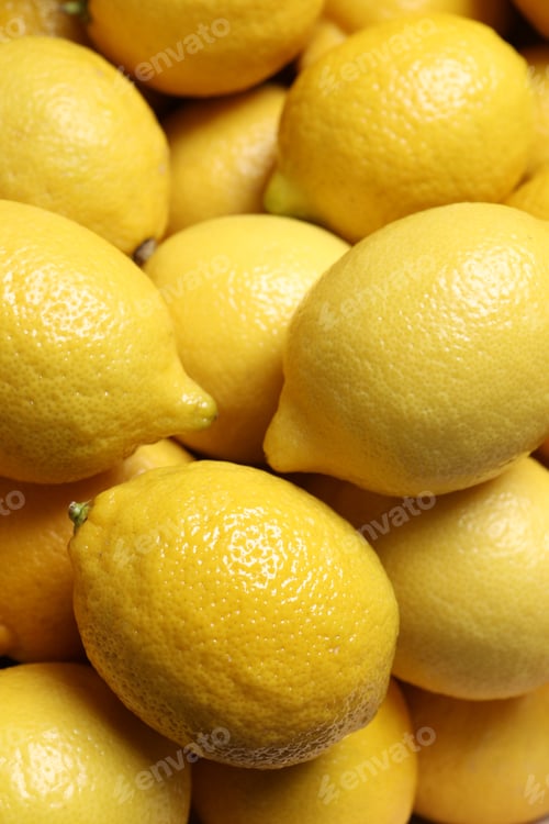 Preview: Fresh lemons as background, closeup. Citrus fruit