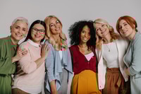 Preview: Group of Smiling Women Posing Together Indoors