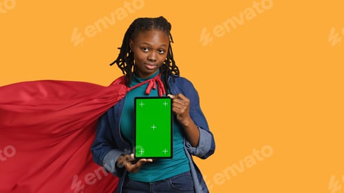 Preview: Radiant person doing hero cosplay recommending mockup tablet, studio background