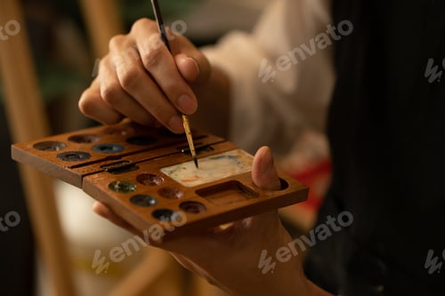 Preview: Close-up of Hands Holding Wooden Artist's Palette