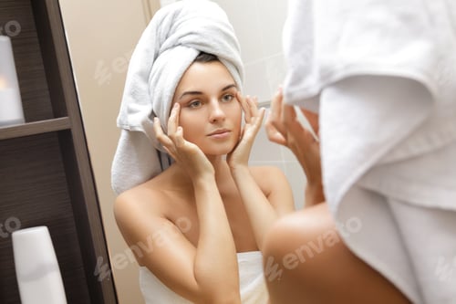 Preview: Beautiful woman is looking in the mirror