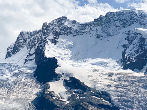 Preview: A glacier and snow covered mountain tops in the Swiss Alps