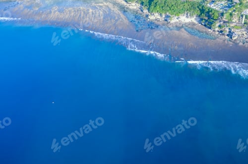 Preview: Aerial View of Coastal Shoreline with Clear Blue Waters
