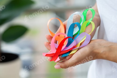 Preview: Female doctor holds colored ribbons symbolize awareness of various diseases
