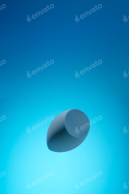 Preview: Beauty blender on blue turquoise isolated background for cosmetics