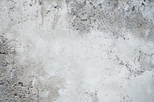 Preview: Cracked concrete wall covered with gray cement surface. Grey old wall with shabby damaged plaster