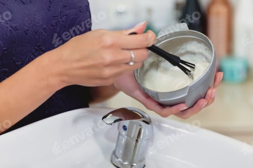 Preview: Hairdresser prepares composition for hair coloring