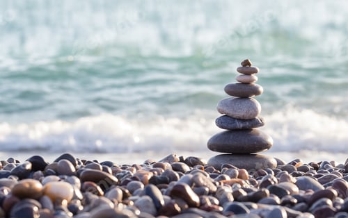 Preview: Pyramid of sea stones on pebbles of the sea shore