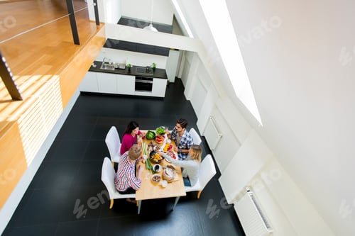 Preview: Young people have a dinner in modern kitchen