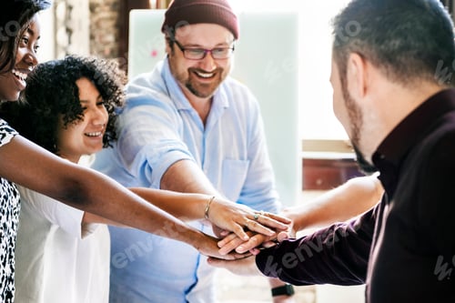 Preview: Diverse startup business team stacking hands