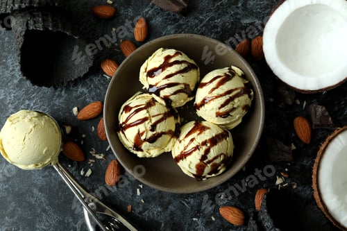 Preview: Bowl with ice cream balls and ingredients on black smokey table