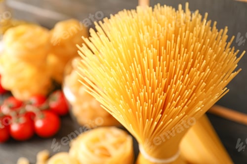 Preview: Composition with pasta cooking ingredients on wooden table, space for text and closeup