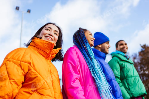 Preview: Multiracial group of young friends meeting outdoors in winter