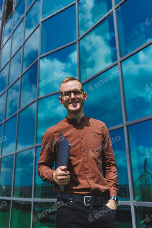Preview: Cheerful businessman, formally dressed, pleased with received good news about contract details