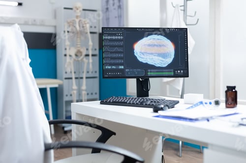 Preview: Computer with mri brain on screen standing on table in empty examination