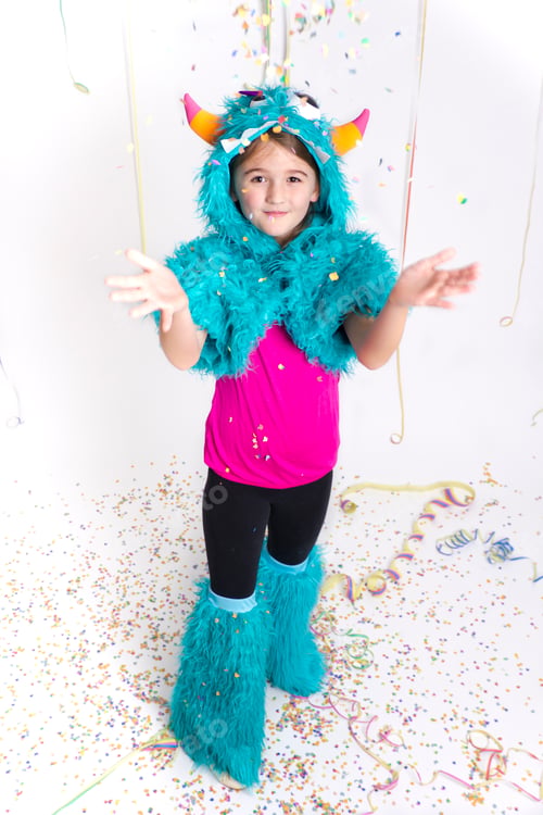 Preview: Smiling girl masquerade as a monster throwing confetti