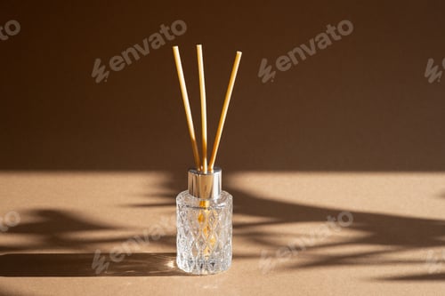 Preview: Aromatic reed air freshener on brown background hard shadow. Aromatherapy sticks.