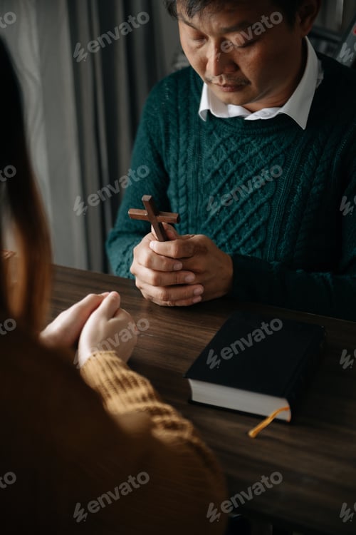 Preview: Two people praying together with Bible and cross on table, symbolizing faith, hope, love, and