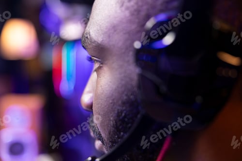 Preview: Man wears headphones playing game, teaching subscribers esport skills, close up